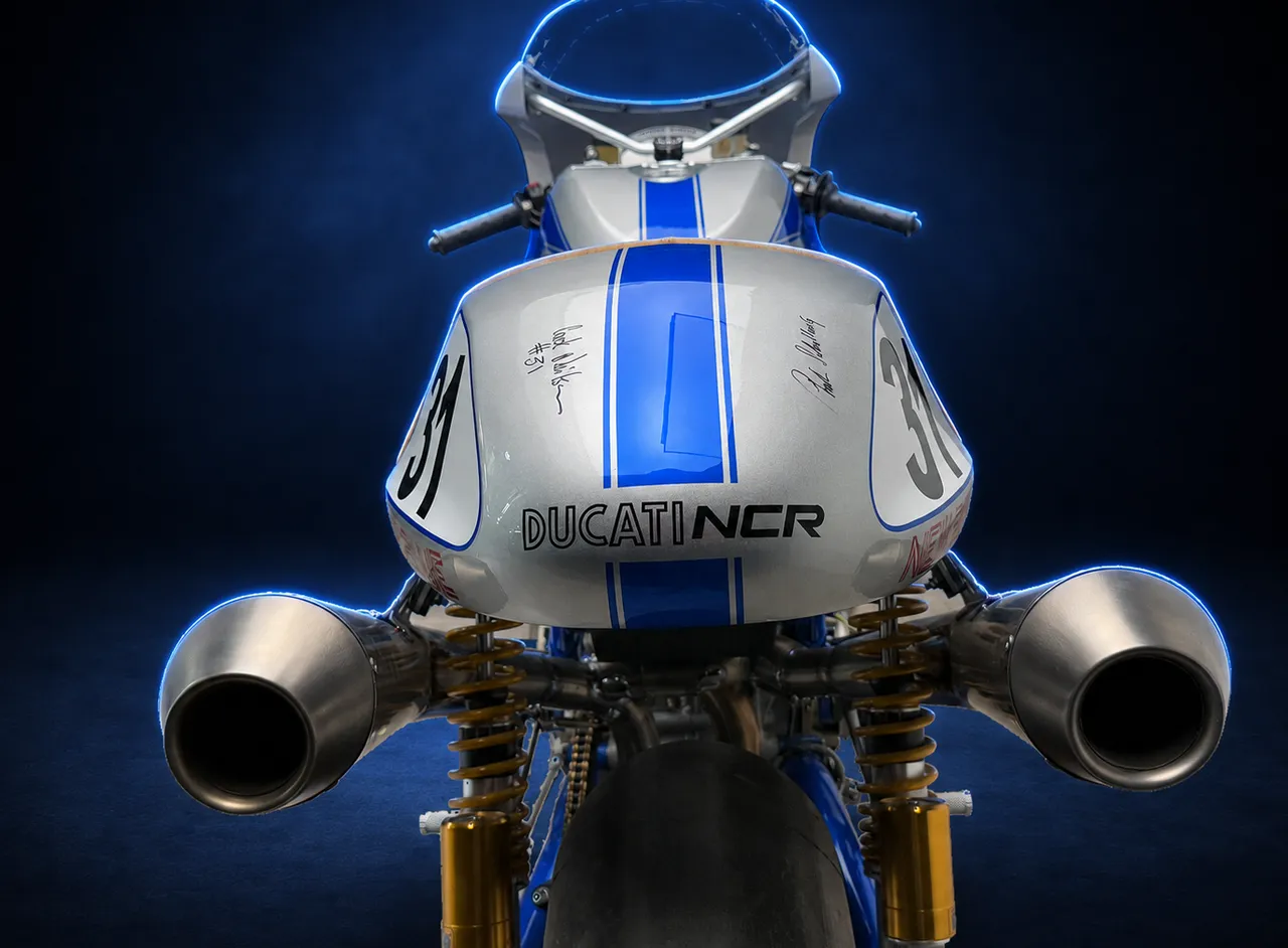 Number twelve from directly behind, both exhausts pointing at the camera